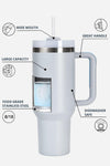 A white insulated mug with a clear viewing window showing water inside. Labels point to various features including "Wide Mouth," "Large Capacity 40 oz," "Great Handle," "Food Grade Stainless Steel," "8/18," and "Dishwasher Safe." A straw is attached to the lid, making it a perfect spill-proof travel tumbler. Introducing the Indestructible Travel Cup by looselyboho.