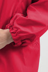 Close-up shot of a person wearing the looselyboho VIVA MAGENTA WINDBREAKER with elasticized cuffs. The person's arm is slightly bent, revealing the inside of the forearm and part of the hand against a plain, light background—perfect for outdoor activities.